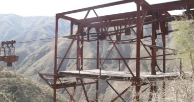 Eski teleferik Chilecito-La Mejicana benim. Ayrıntı vagonlar kablo ve üçüncü istasyonu platformu üzerinden asılı. Dağlar ve arka plan, bitki örtüsü. Kamera yana doğru hareket eder. Ulusal Miras