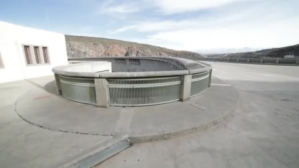 Detail van halve circulaire concrete steun van Agua de Toro Dam. Hand-het gehouden camera naar metalen reling en leunend naar beneden kijken de enorme afgrond lopen. San Rafael, Argentinië — Stockvideo