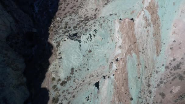 Aerial senital drone scene of colourful blue green sandy and rocky mountains. Camera approaches sand dunes with vegetation, eroded landscape in Uspallata, Mendoza, Argentina. — Stock Video