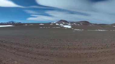 Kara, karanlık, desertic, rocky manzara karlı dağlar ve volkanlar, arka plan ile seyahat. Gezi için Andes Altiplane, Brava Lagoon macera için 4 x 4 yol kapalı. Rioja