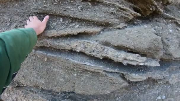 Walking and touching volcanic walls of dry rocky river towards Malacara Volcano. Adventure tourism in natural environment. Mendoza, Argentina. — Stock Video