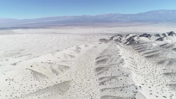 Légi drone jelenet sivatag világos világos bézs színű homok. A kamera mozgó előre megtaláló dűnék és az Andok-hegységre a háttérben. Taton, Catamarca tartomány, Argentina. — Stock videók