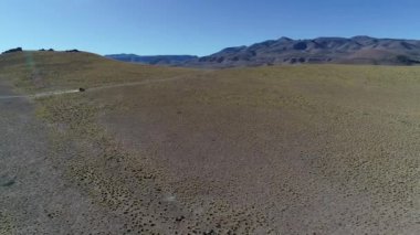 4 x 4 van parça altın peyzaj yüksek dağın yoldan hava sahne. Geniş vadi otlar ve yaşlı kayalar ile keşfetmek. Galan volkan gezi, Antofagasta de la Sierra