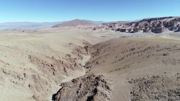 Escena aérea de drones del estrecho cañón naranja en la alta meseta dorada. Paisaje desértico, fuera de la pista para la excursión Volcán Galán. Descendiendo. Antofagasta de la sierra, Catamarca, Argentina — Vídeo de stock