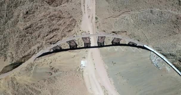 Aerial top view of train in station and old iron bridge. People moving at station. Train of the clouds, tren de las nubes, Salta, Argentina — Stock Video