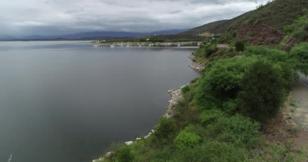 Scena aerea drone di lago circondato da montagne e boschi. Sfondo di boe di ormeggio. Diga di Cabra Corral. Zona turistica, Salta, Argentina — Video Stock