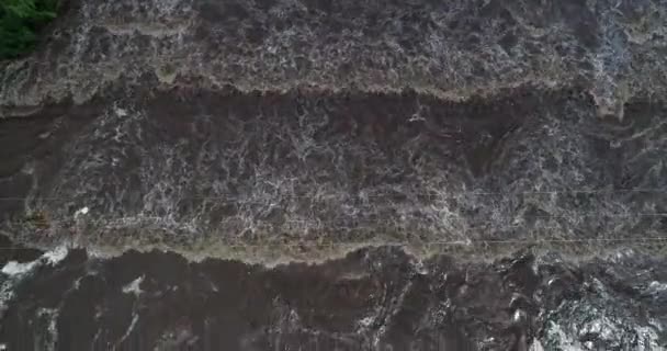 Senital aerial drone scene of flooded bridge, brown muddy water passing over construction. Mina clavero, traslasierra, cordoba argentina — Stock Video