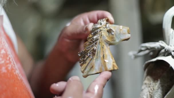 Slow motion shot, man showing horse statue with semiprecious stone. Close up of onix handcraft stone decoration. La Toma, San Luis, Argentina — Stock Video