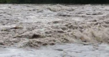 Detail of strong turbulent river, waves and foam of water current. Mina Clavero, Cordoba, Argentina