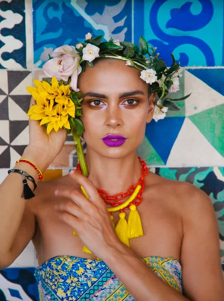 Frida  style portrait on a background of blue wall