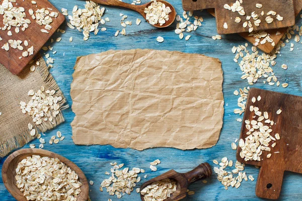 Rolled Oats Top View Blue Table Wooden Spoon — Stock Photo, Image