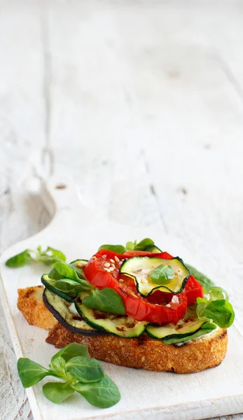 Vegetarian sandwich with fresh cheese, grilled tomatoes, eggplants and zucchini