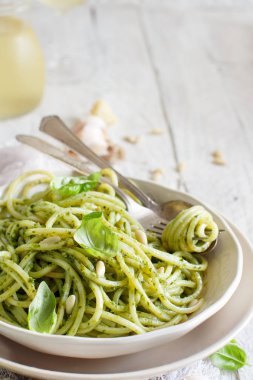 Spagetti makarna pesto sosu, fesleğen, çam fıstığı ve parmesan ile yakın çekim