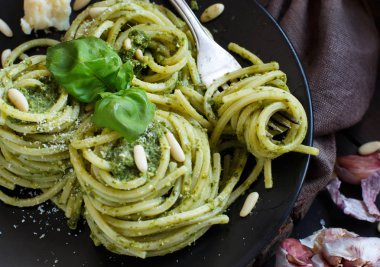 Spagetti makarna pesto sosu, fesleğen, çam fıstığı ve parmesan ile yakın çekim