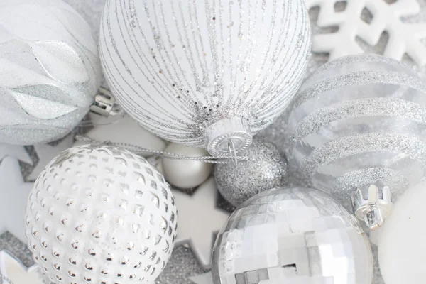 Silver and white Christmas decorations and balls close up