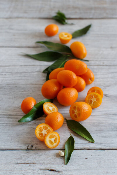 Kumquat fruits on a grey background close up