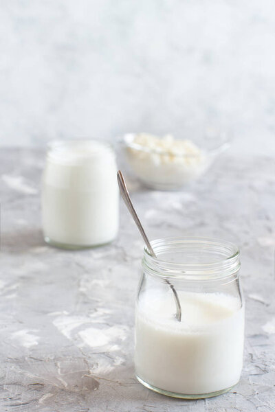 Fermented drink kefir in small bottles and kefir grains