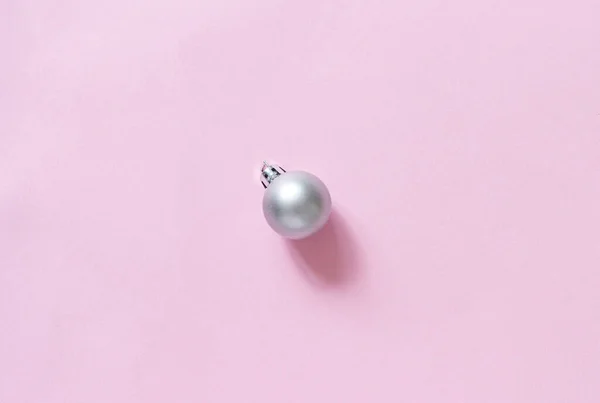 Silver Christmas bauble on a light pink background — Stock Photo, Image