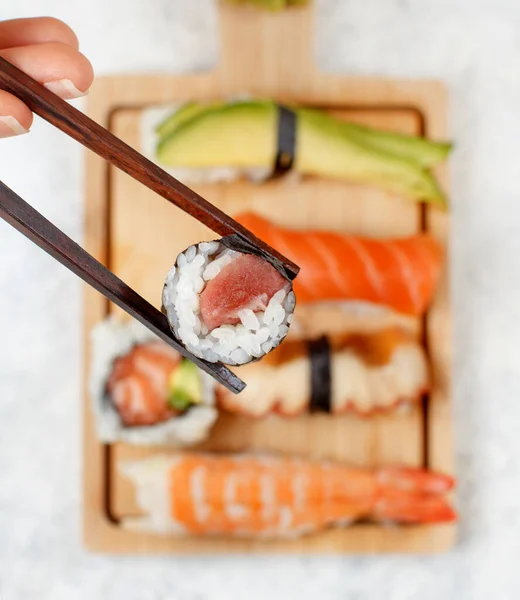 Χέρι Που Παίρνει Ρολό Chopsticks Από Ένα Πιάτο Πάνω Όψη — Φωτογραφία Αρχείου