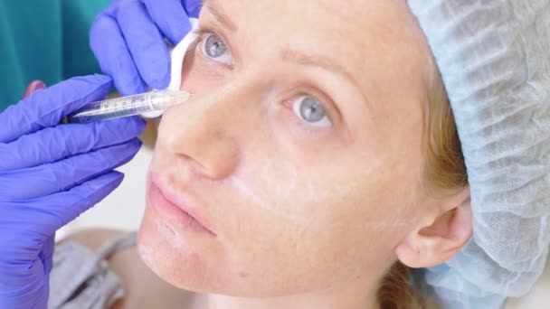 Dokter ahli kecantikan membuat suntikan di wajah pasien wanita itu. konsep keindahan dan kosmologi. 4k. kontur plastik — Stok Video