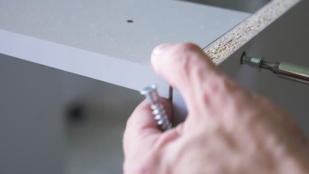 A man collects furniture in a workshop. 4k, slow motion. Bonding and assembly of furniture on the wooden pins — Stock Footage A man collects furniture in a workshop. 4k, slow motion. Bonding and assembly of furniture on the wooden pins Video Clip