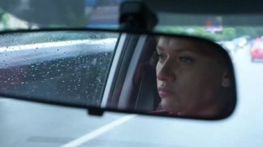 Dikiz aynasından mavi gözler, kadın direksiyonuna bir womans yüzle yansımasıdır. 4k, ağır çekim