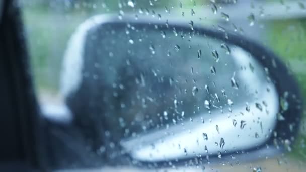 Drive in the rain View from inside the car, see the cars mirror. 4k, slow motion — Stock Video