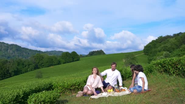 Семейный пикник на поляне среди чайной плантации. концепция путешествий, отдыха. стиль жизни. 4k . — стоковое видео