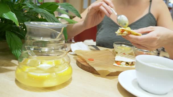 Женщина ест в кафе кесадилья с чили и начос. 4k, slow motion — стоковое видео