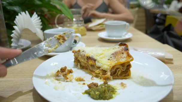 Man Eats Lasagna Restaurant Fork Knife Close Slow Motion — Stock Video