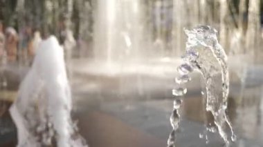 Çocuk su şehir Çeşme akışında oyun. Yaz Güney. 4k, ağır çekim, görüntü