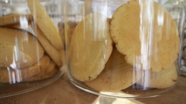 Bisküvi şekerleme dükkanı penceresinde cam kavanozlara. 4k, ağır çekim