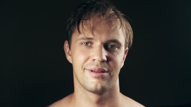 Young man with taped mouth. on a black background. 4k. — Stock Video