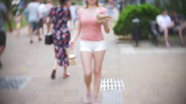 La chica sale de la pastelería con croissants, un donut y café para una compañía de amigos. Borroso, primer plano. 4k, cámara lenta. para llevar — Vídeo de stock