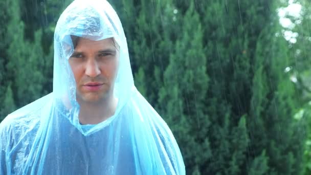 Muž v pláštěnka na déšť. 4k, pomalý pohyb. — Stock video