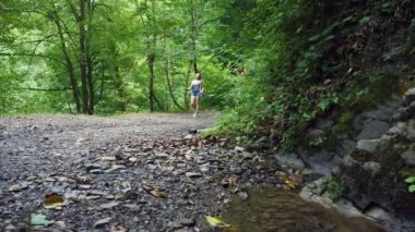 Kız blogger ormana dağlar arasında yürürken bir kaydını tutar. Güzel doğa. 4k, ağır çekim