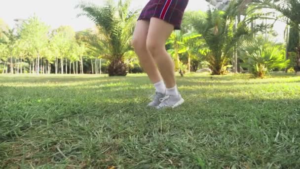 美しい赤毛の少女公園で踊っています。ヤシの木の背景に熱帯公園で踊るミニ スカートの女性。4 k、スローモーション — ストック動画