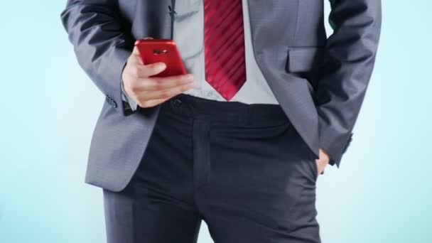 4K. Slow motion. Close-up. Colorful background. A young man uses a red phone — Stock Video