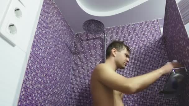 A person taking a shower washes his hair . Body care at home. daily procedure for adults. — Stockvideo