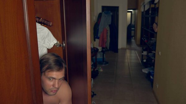 the naked man is hiding in the wardrobe. he goes out of the closet and runs away from the mistresss house through the front door. 4k,