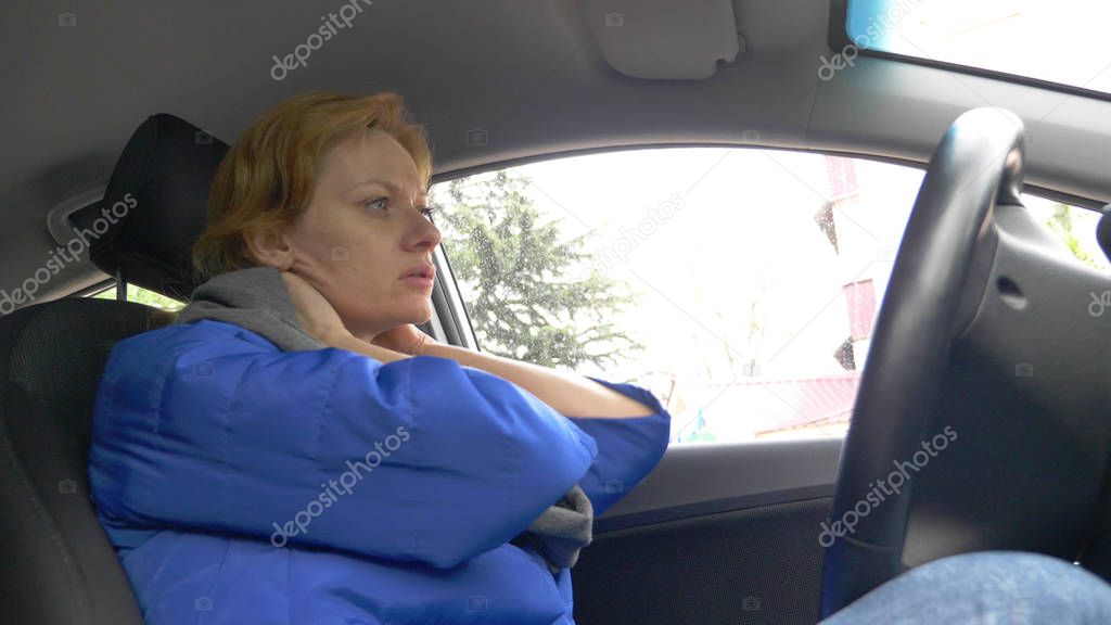 the driver of the woman fell asleep on the drivers seat on the side of the road. Waiting in the car.