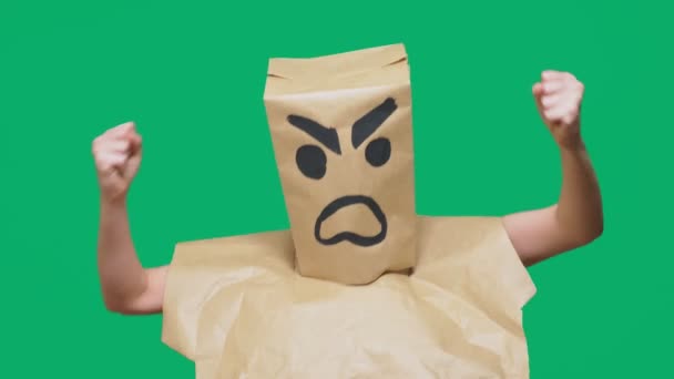 Concept of emotion, gestures. a man with a package on his head, with a painted smiley aggressive, angry. — Stock Video