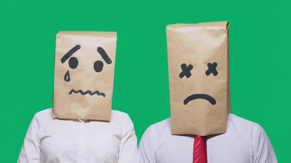 Concept of emotions, gestures. a couple of people with bags on their heads, with a painted emoticon, sad, crying, tired — Stock Photo, Image