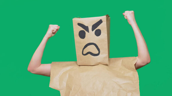 concept of emotion, gestures. a man with a package on his head, with a painted smiley aggressive, angry.