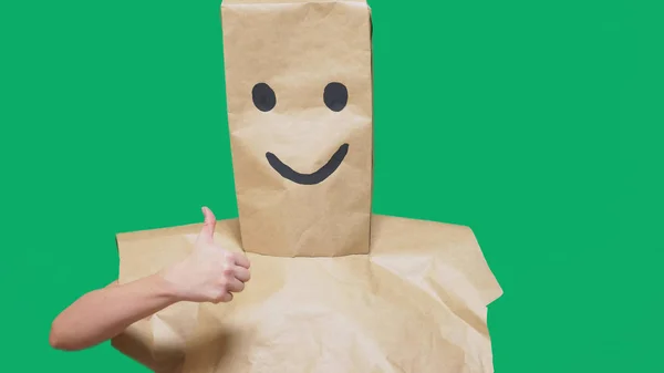 Concept of emotions, gestures. a man with paper bags on his head, with a painted emoticon, smile, joy — Stock Photo, Image