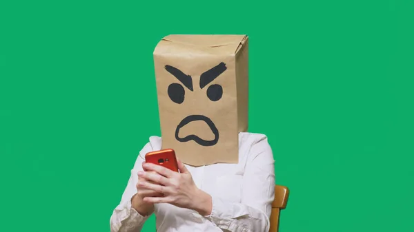 Concepto de emoción, gestos. un hombre con un paquete en la cabeza, con una sonrisa pintada agresivo, enojado. hablando por un teléfono celular — Foto de Stock