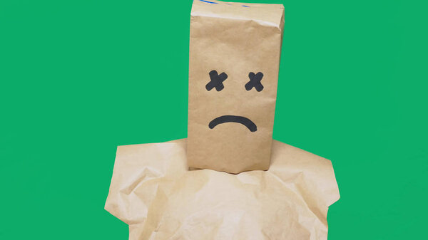 concept of emotion, gestures. a man with a package on his head, with a painted smiley, exhausted, tired