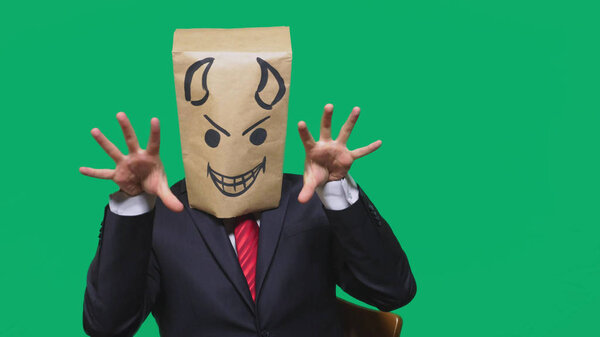 concept of emotion, gestures. a man with a package on his head, with a painted smiley angry, sly, gloating