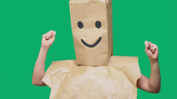 Concept of emotions, gestures. a man with paper bags on his head, with a painted emoticon, smile, joy — Stock Photo, Image