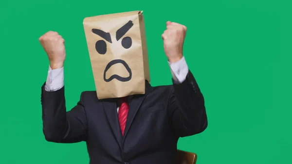 Concept of emotion, gestures. a man with a package on his head, with a painted smiley aggressive, angry. — Stock Photo, Image